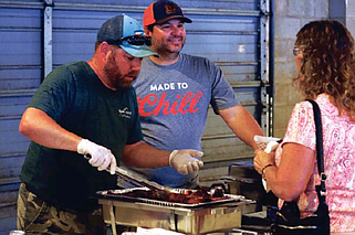 News Tribune file photo: GPS Financial Strategies attendants prepare their servings for guests to take as they pass by during the 2022 Capital City Cook-Off.